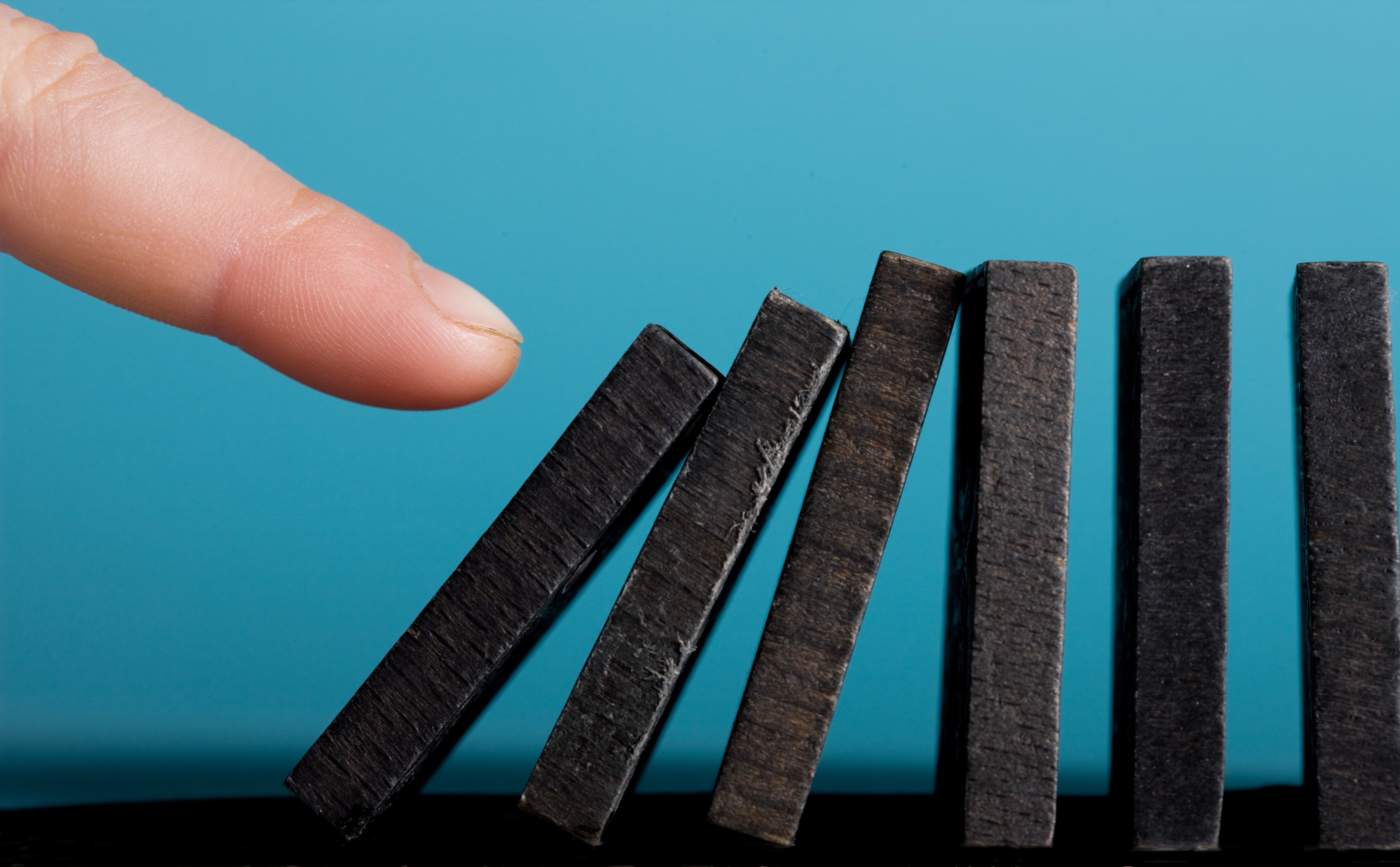 finger pushing dominos